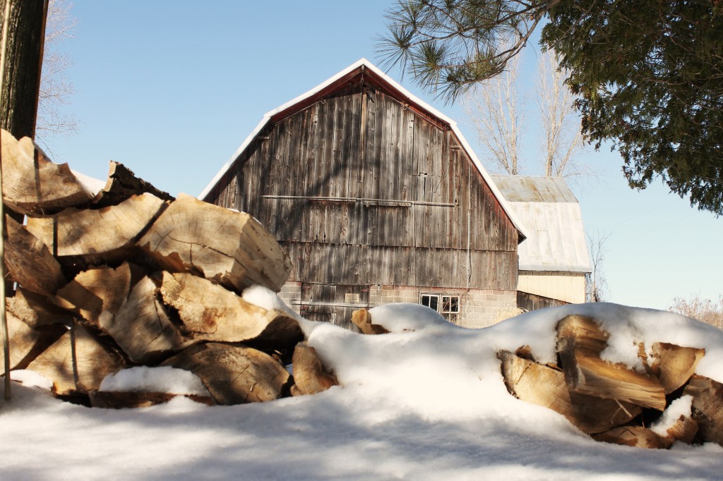 barn in snow with lumber