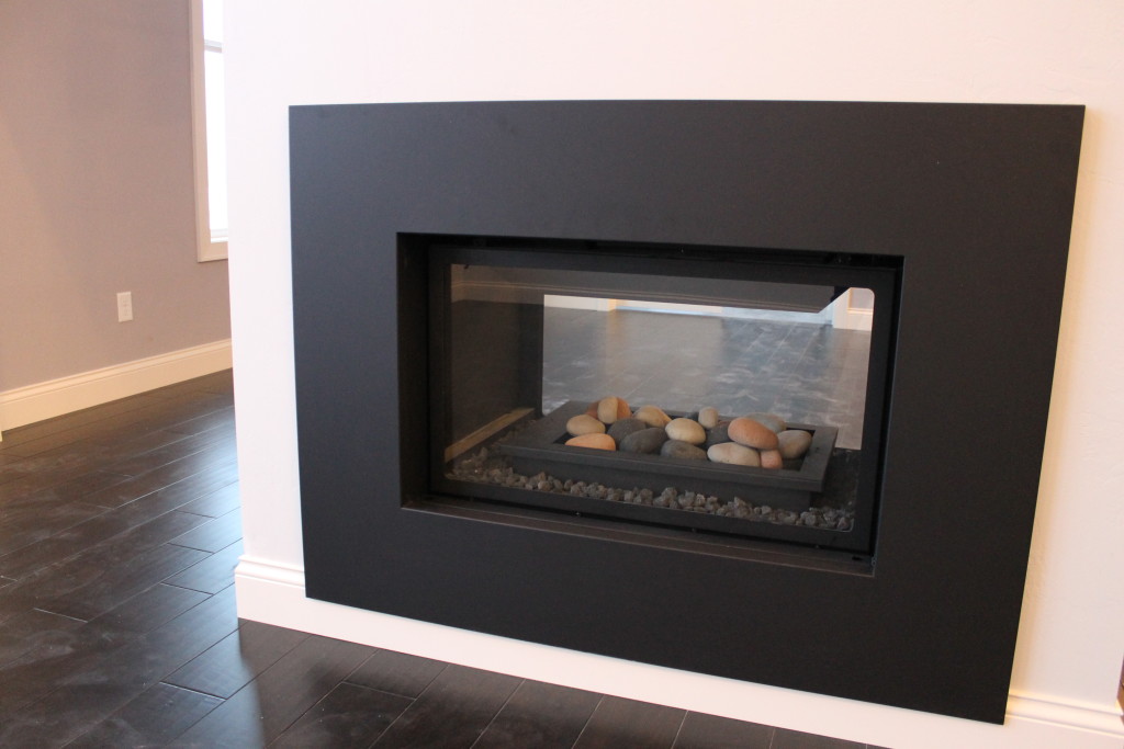 double sided fireplace with rocks