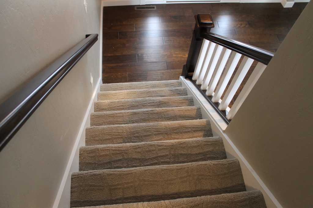 H open stairs with hardwood foyer