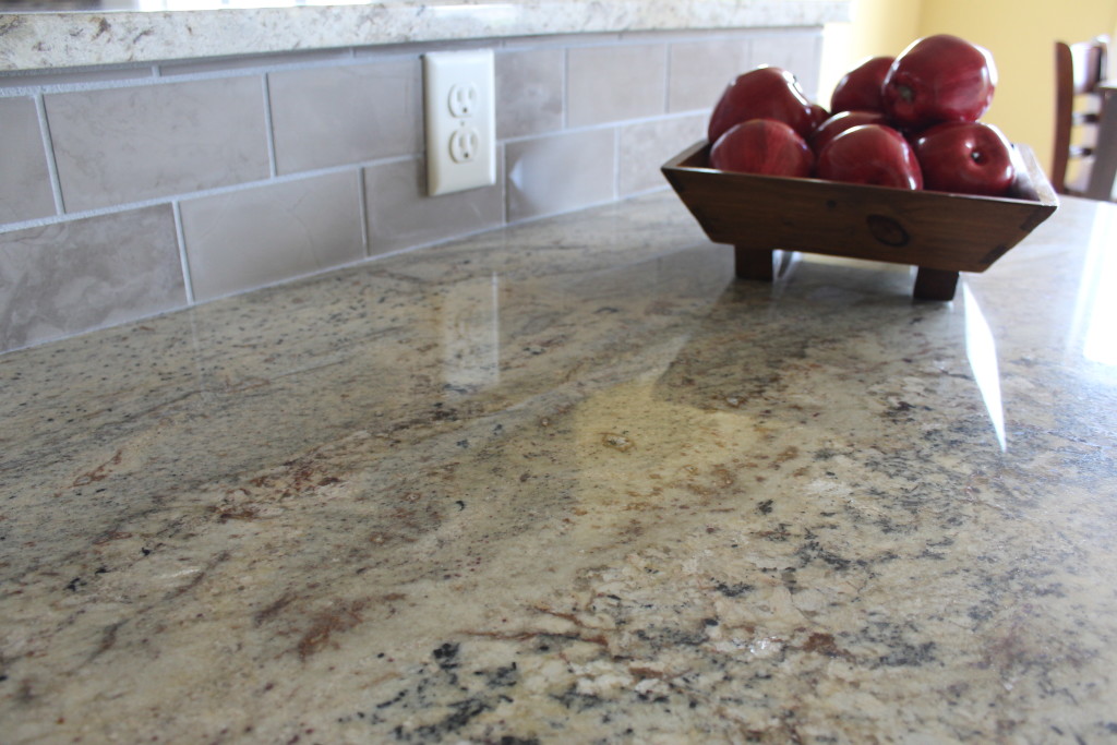 warm granite counter with light backsplash