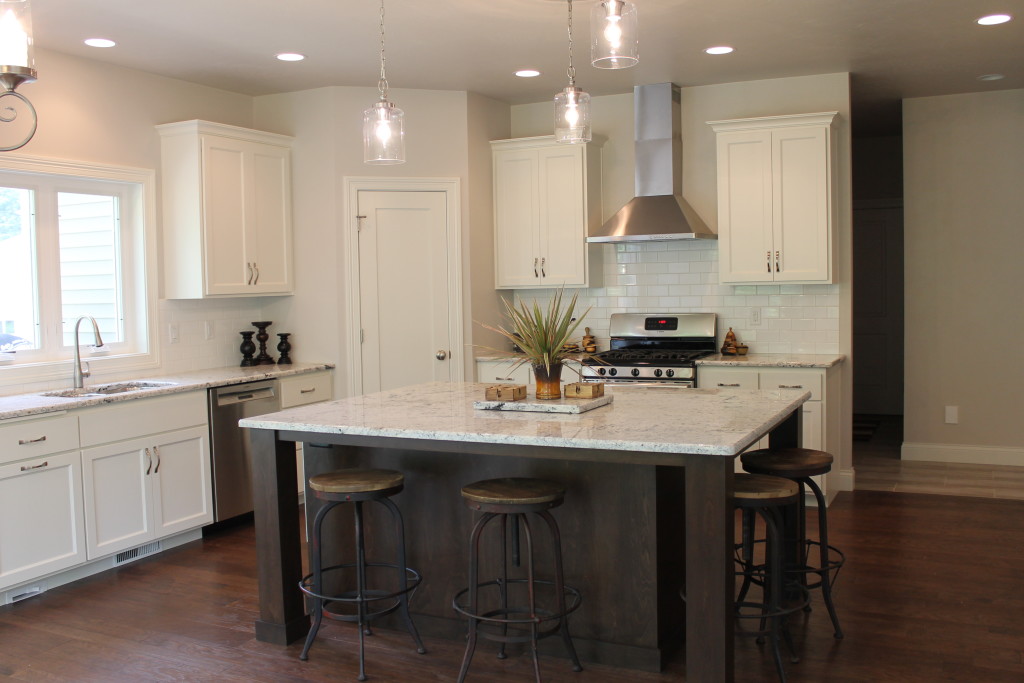 white kitchen with stained island and white granite