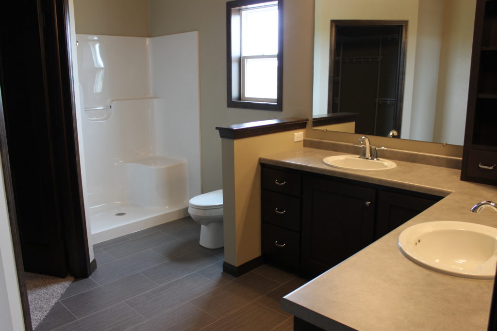 l-shaped master bath with double sinks on amethyst