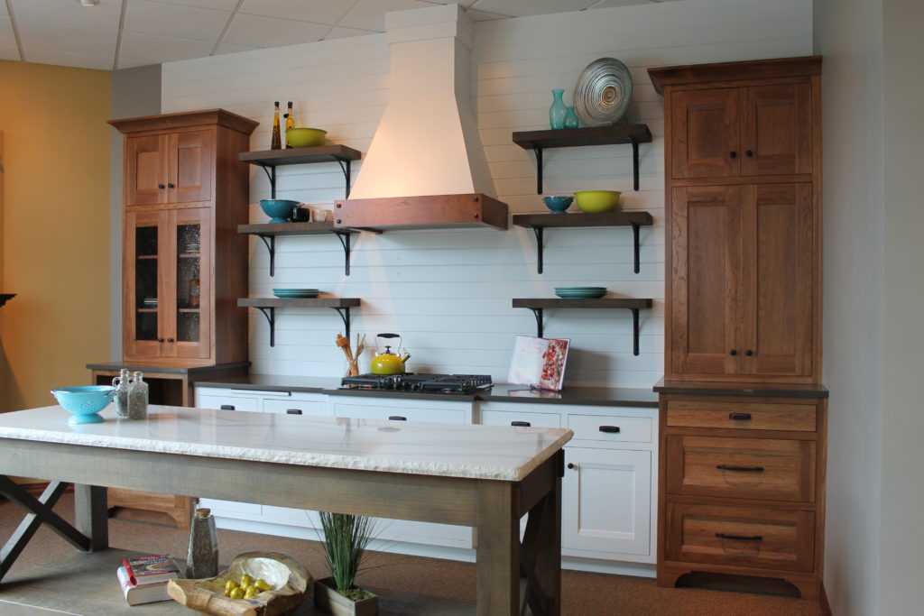 farmhouse-kitchen-with-white-and-stained-cabinets-decorative-range-hood-and-open-shelving