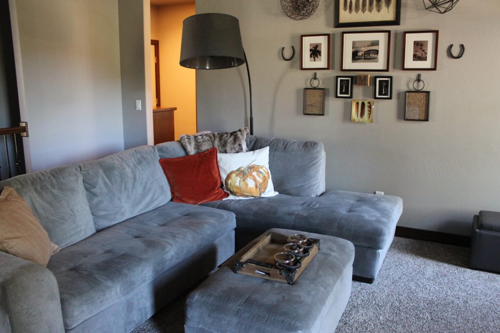 living-room-with-pumpkin-pillow-and-photo-wall