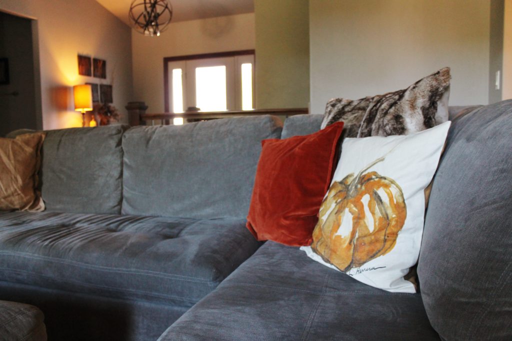 living-room-with-pumpkin-pillow-looking-at-foyer