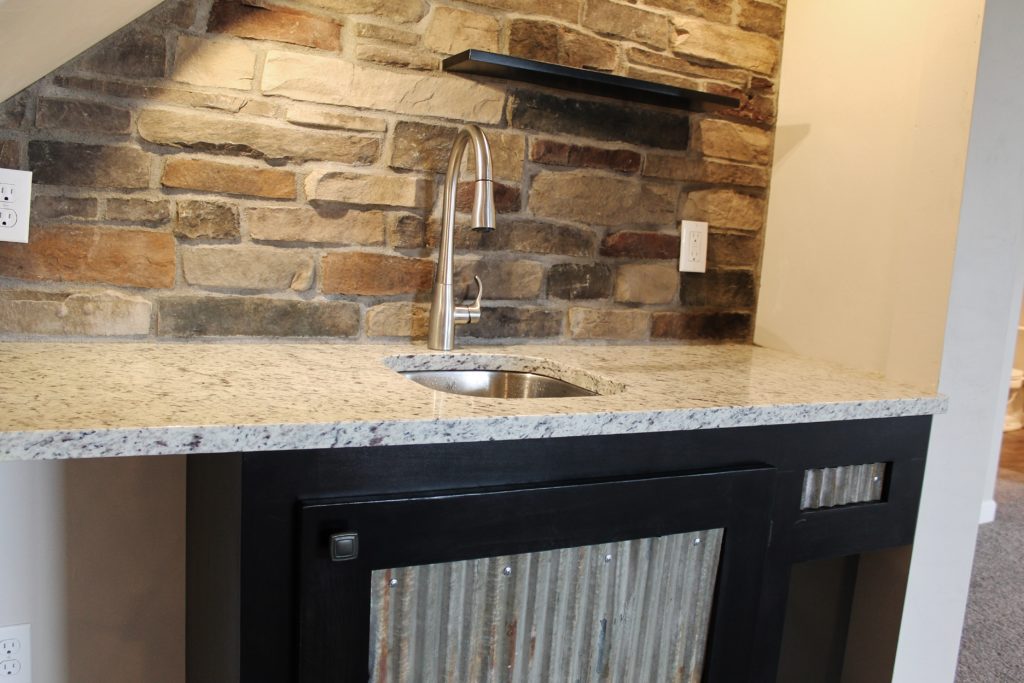 stone-wall-behind-bar-sink-in-westbury-basement-lowerlevel